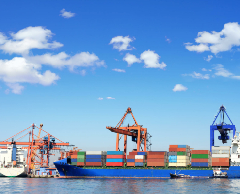 Cargo ship, containers and cranes in sea port